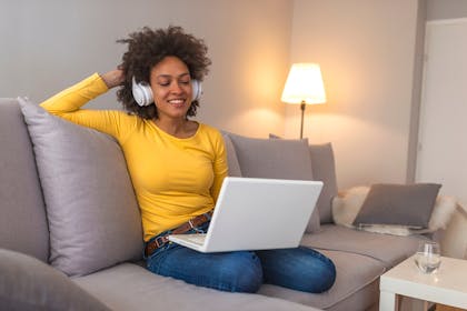 Woman on laptop with headphones