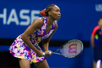 Venus Williams playing tennis in brightly coloured outfit