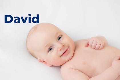 Baby lying down smiling. Name David written in text