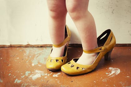 toddler wearing adult shoes