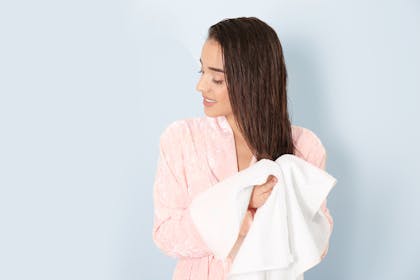 woman drying her hair with a towel