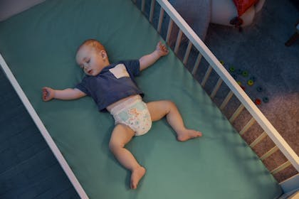 Baby sleeping in cot 