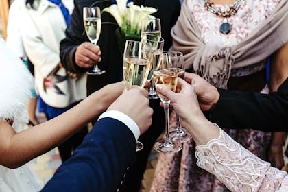 group of people raising glasses of alcohol