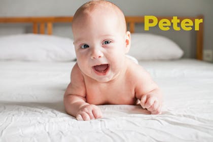 Red headed baby smiling. Name Peter written in text