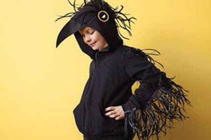 Boy dressed as a black crow