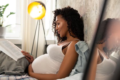 pregnant woman reading a book