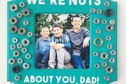 'We're nuts about you, dad!' DIY frame decorated with nuts and bolts and a family photo