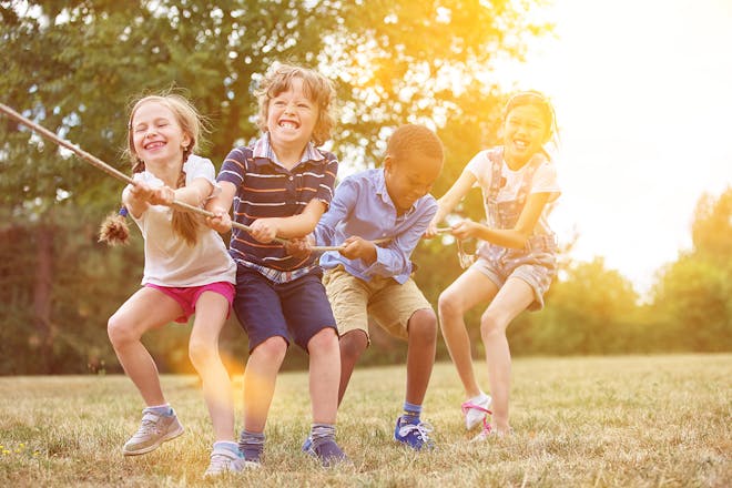 group of children pulling on rope in game of tug of war