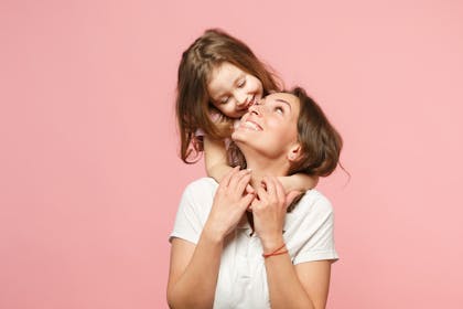 Mum and daughter with pink background