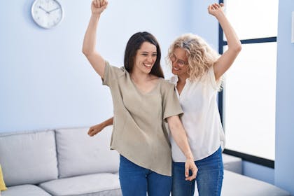 Mother and daughter dancing at home
