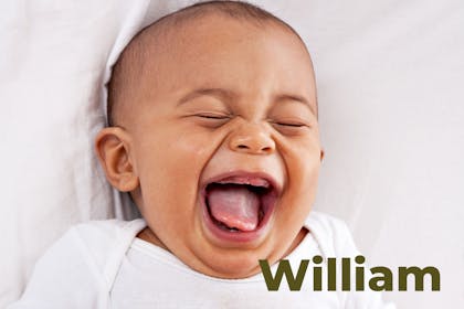 Baby lying down and laughing. Name William written in text