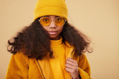 Girl dressed all in yellow with yellow sunglasses
