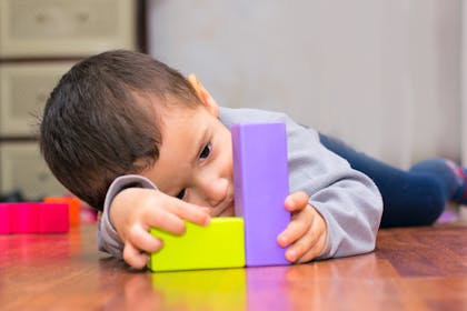 autistic child playing with bricks
