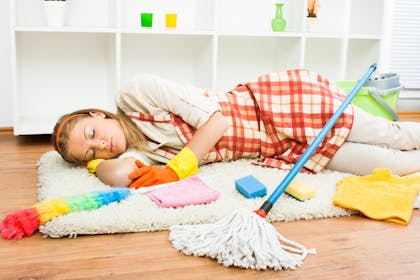 Mum sleeping on floor surrounded by cleaning products