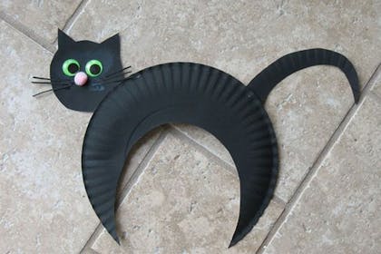 A black cat made out of paper plates