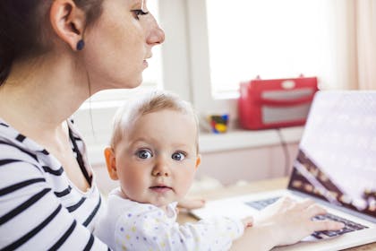 Woman on maternity leave with baby on lap