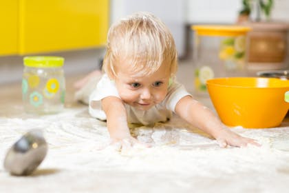 Toddler playing with flour
