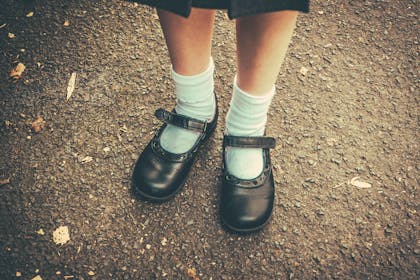 Girl's feet in school shoes