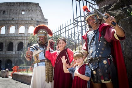Two men and two children dressed as ancient Romans at the colliseum