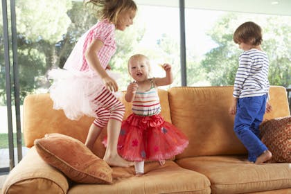 children jumping on sofa