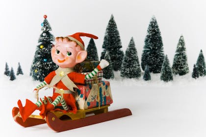 christmas elf delivering presents on a sledge