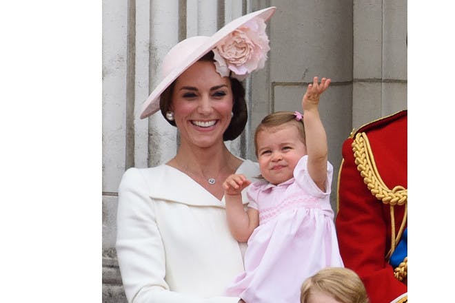 Kate Middleton and Princess Charlotte waving on balcony