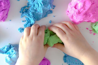 Child's hands playing with playdough