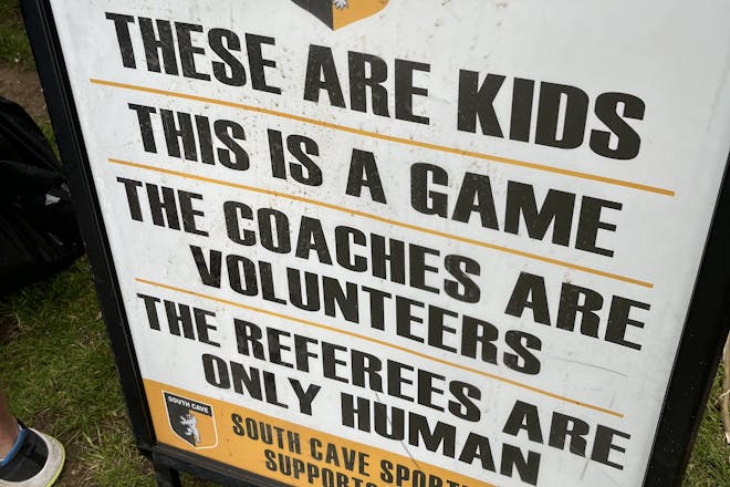 A sign at a grassroots football match