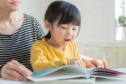 Mum reading a book with young girl