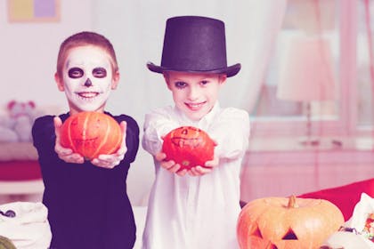 kids on halloween with pumpkins