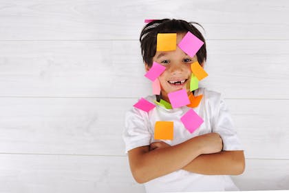 Boy with post it notes on face