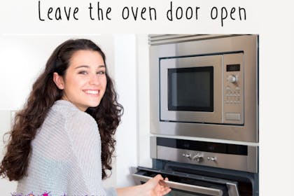 woman opening oven