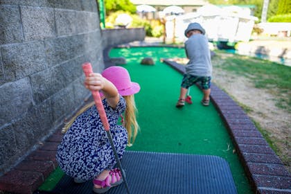 Young boy and girl playing crazy golf