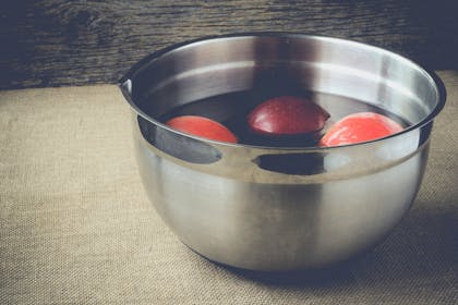 Apples in bowl of water for bobbing