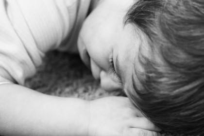 little boy crying on the carpet