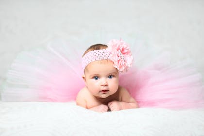Baby wearing a pink tutu and flower headband