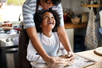 child baking with parent