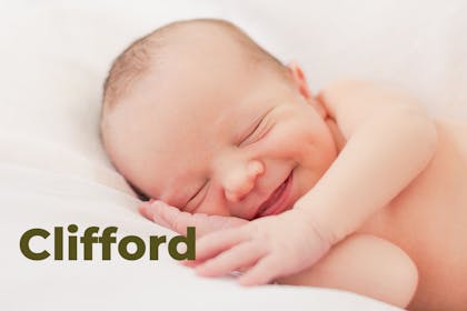 Smiling baby lying down, name Clifford written in text