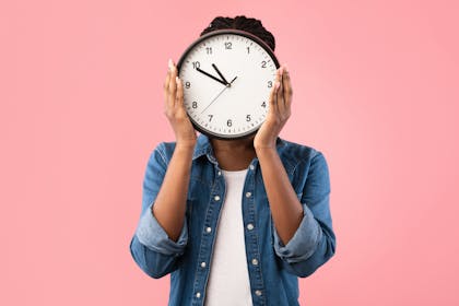 woman holding a clock