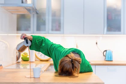 tired woman with head on counter