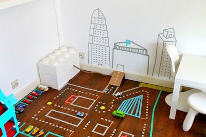 DIY washi tape car track on the floor in kid's play room