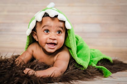 Baby boy with dinosaur towel