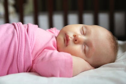 Baby sleeping in cot