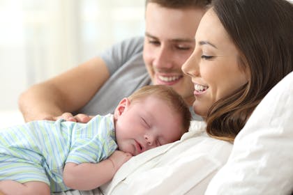 mum and dad with sleeping baby