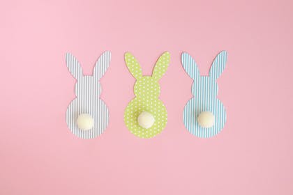 rabbits cut from paper with pompom tails