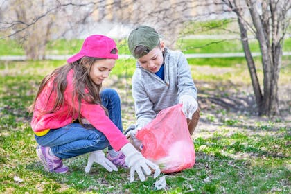 boy and girl collecting litter in the park
