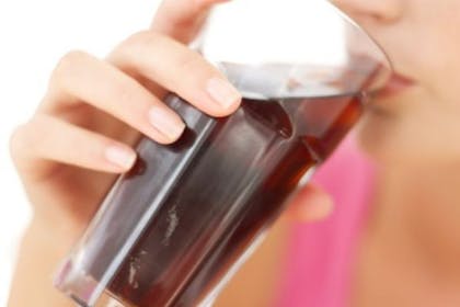 woman drinking glass of cola