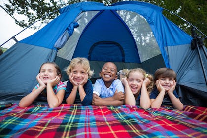 Group of children smiling in a tent