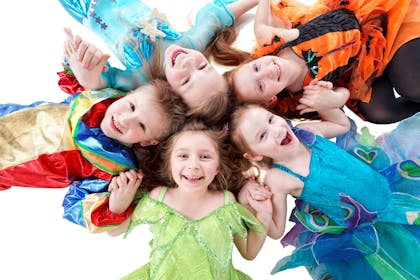 A group of smiling kids in fancy dress