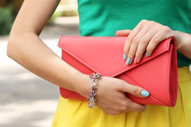 woman holding pink purse